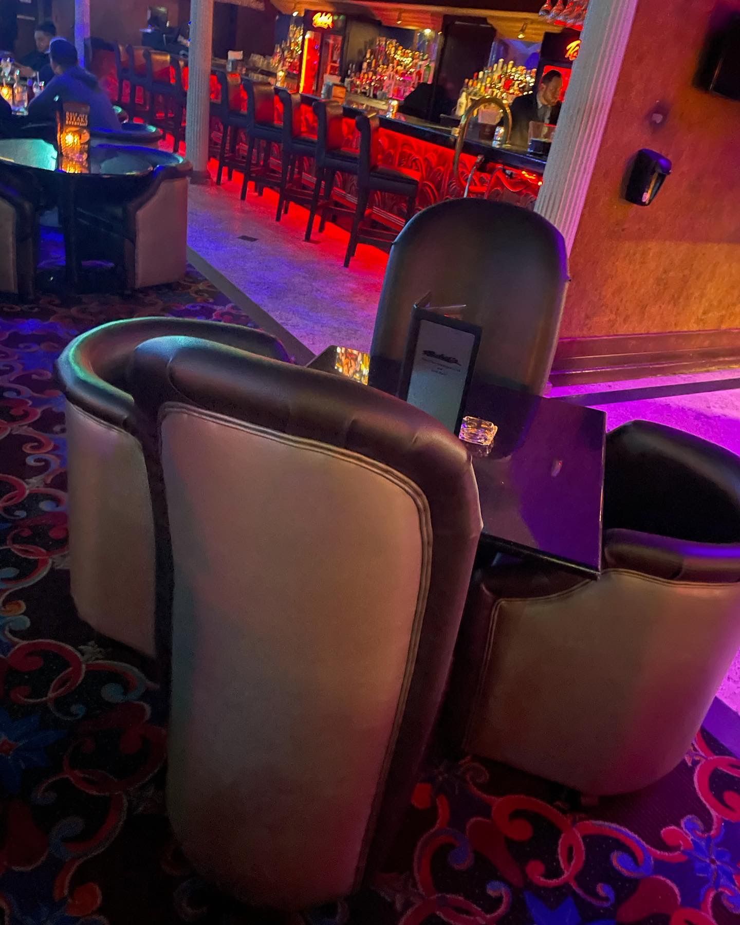 tables with parlor chairs around them in a nightclub