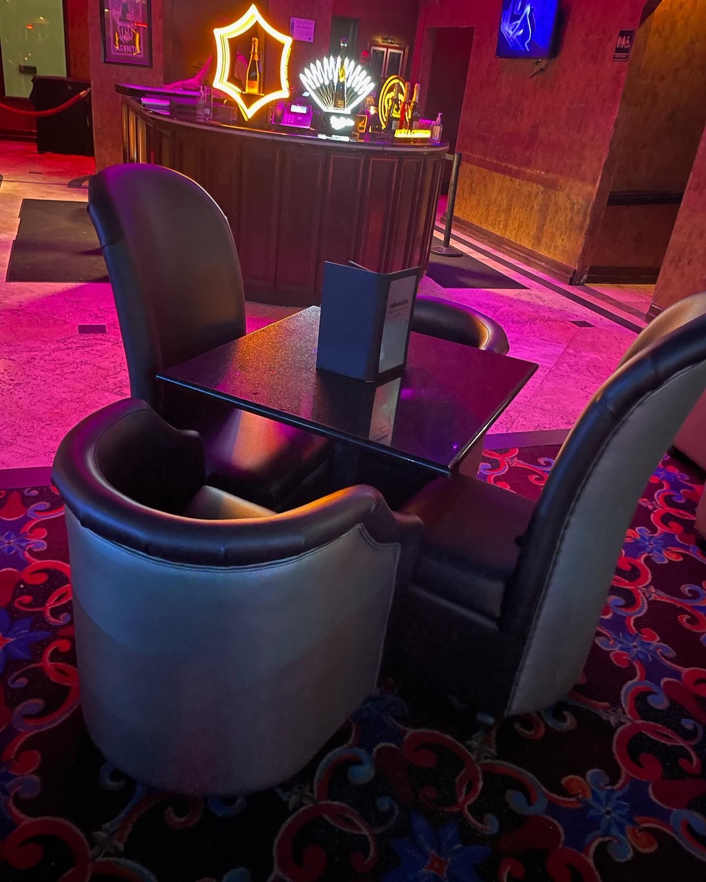 tables with dining and parlor chairs around them in a nightclub